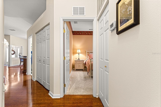 hallway with hardwood / wood-style flooring