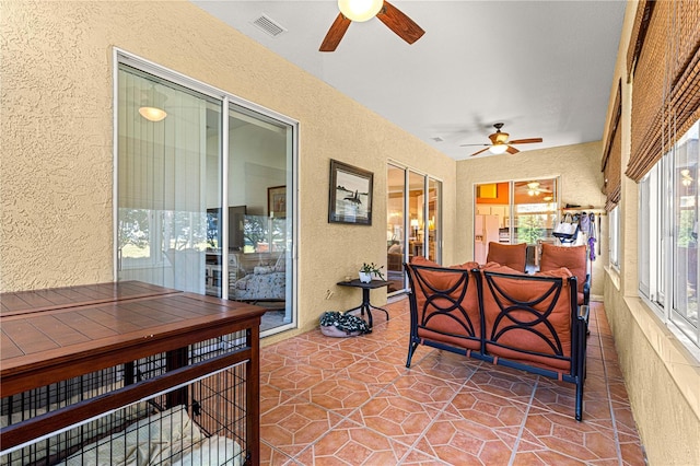 sunroom featuring ceiling fan