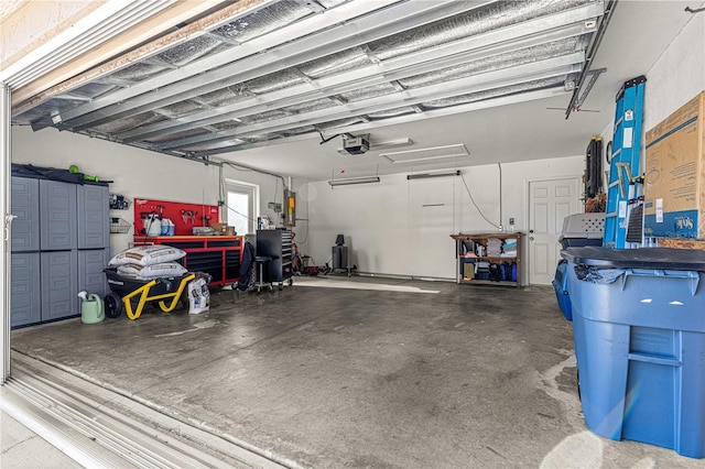 garage with a garage door opener and a workshop area