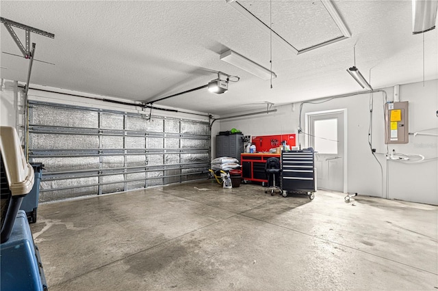 garage with a garage door opener and electric panel