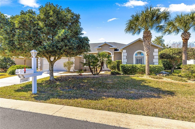 view of front of property featuring a garage and a front yard