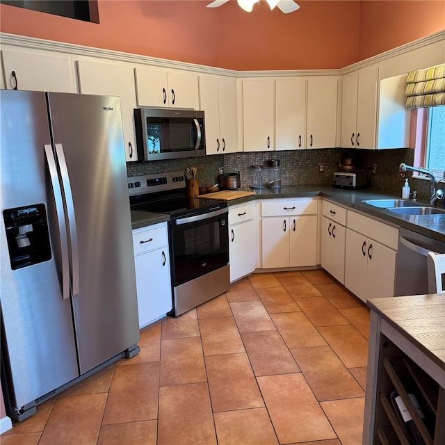 kitchen featuring appliances with stainless steel finishes, light tile patterned floors, and a sink