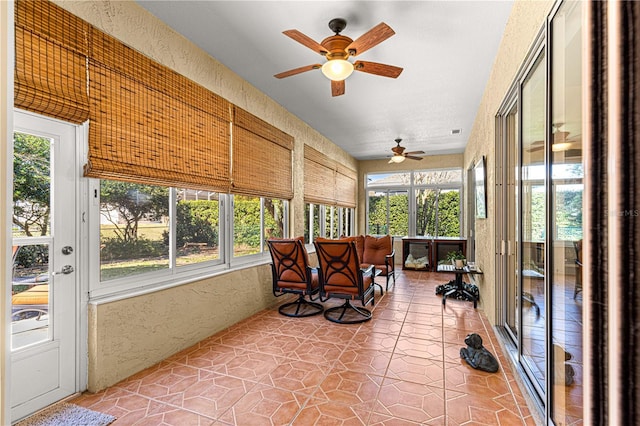sunroom with a ceiling fan