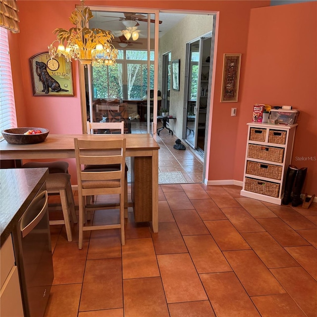 dining area with tile patterned floors and ceiling fan with notable chandelier