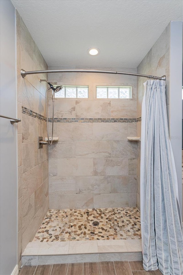 bathroom featuring a shower stall and a healthy amount of sunlight