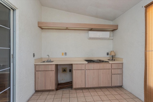 kitchen with a textured wall, light countertops, and a wall mounted AC