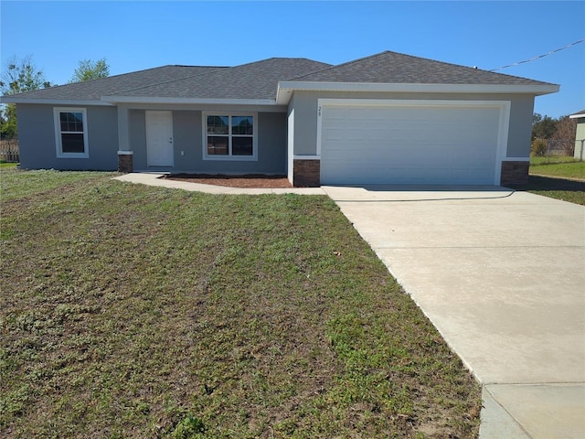 single story home with driveway, an attached garage, a front yard, and stucco siding