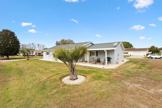 back of house with a patio area and a lawn