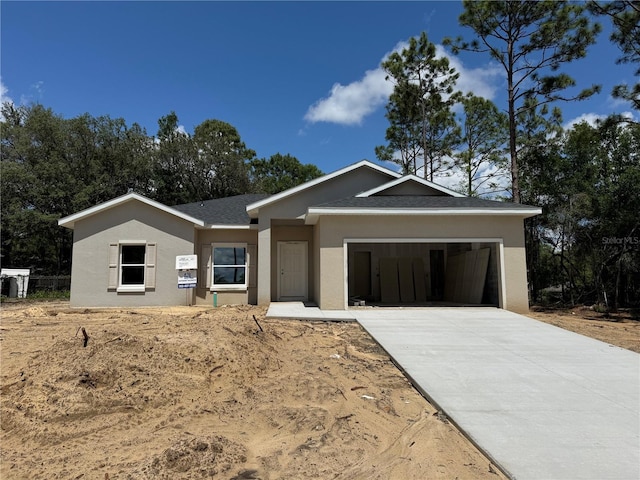 8827 N Mendoza Way, Citrus Springs, FL 34434 - view of front of home featuring a garage, roof with shingles, stucco siding, and concrete driveway