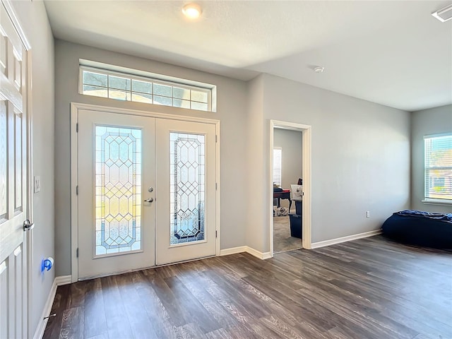 foyer entrance featuring french doors, visible vents, dark wood finished floors, and baseboards