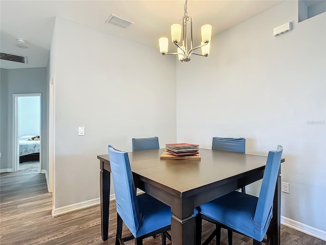 dining room with dark wood-style floors, visible vents, baseboards, and an inviting chandelier