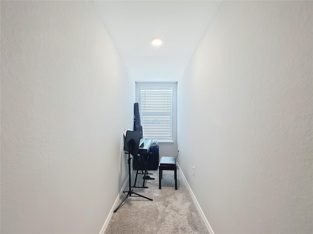 home office featuring baseboards and light colored carpet