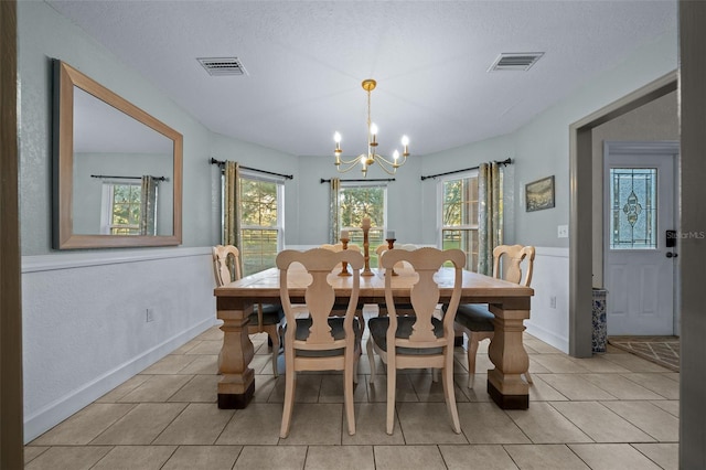 4161 NE 185th Ave, Williston, FL 32696 - tiled dining space with a textured ceiling and an inviting chandelier