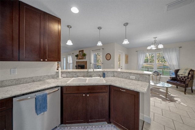 4161 NE 185th Ave, Williston, FL 32696 - kitchen with stainless steel dishwasher, kitchen peninsula, sink, and hanging light fixtures