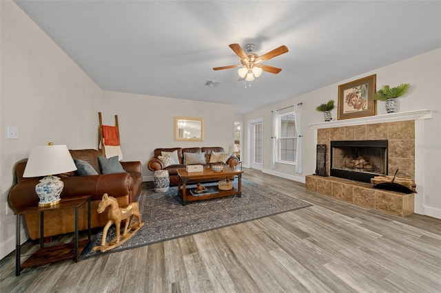 4161 NE 185th Ave, Williston, FL 32696 - living room with light hardwood / wood-style floors, a tile fireplace, and ceiling fan