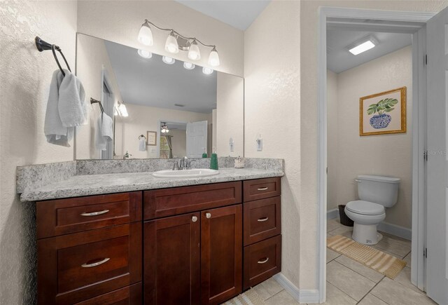 4161 NE 185th Ave, Williston, FL 32696 - bathroom featuring tile patterned flooring, vanity, and toilet