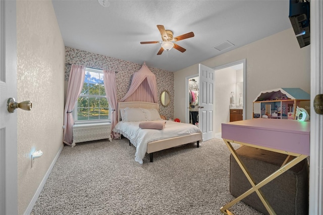 4161 NE 185th Ave, Williston, FL 32696 - carpeted bedroom with connected bathroom, a spacious closet, and ceiling fan