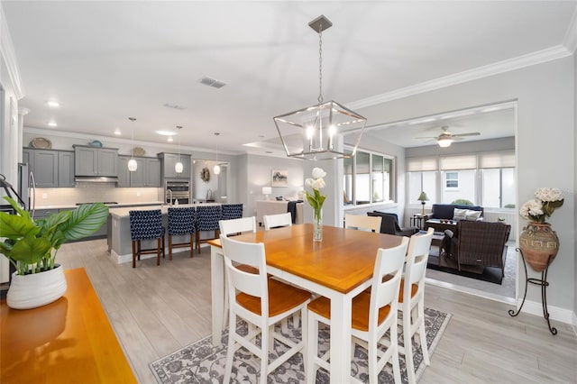 dining room with ceiling fan, light wood-style flooring, recessed lighting, visible vents, and crown molding