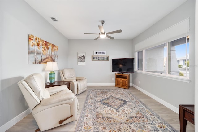 living area with a ceiling fan, light wood-style flooring, visible vents, and baseboards