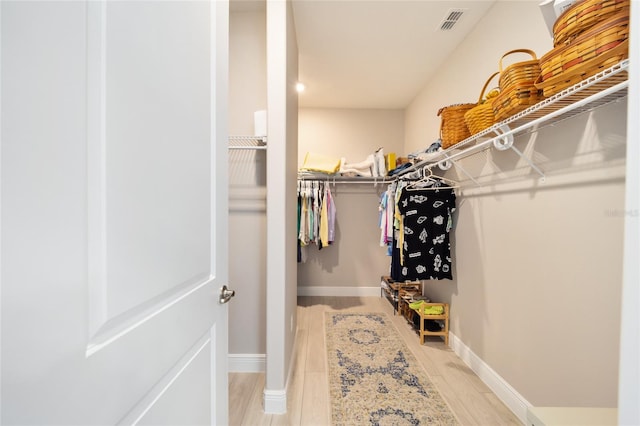 spacious closet with light wood-type flooring and visible vents