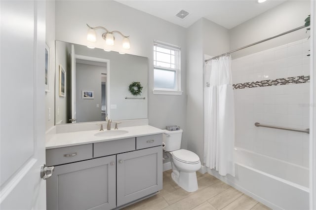 full bathroom featuring shower / bath combo, visible vents, toilet, wood tiled floor, and vanity