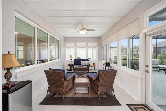 sunroom / solarium featuring ceiling fan