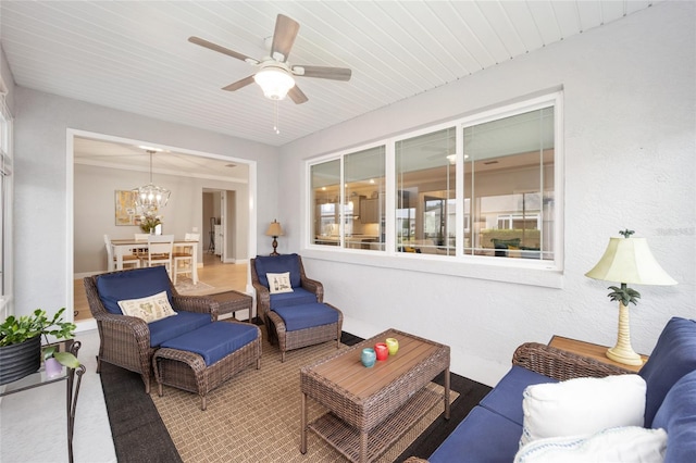 interior space featuring wood ceiling, plenty of natural light, and ceiling fan with notable chandelier