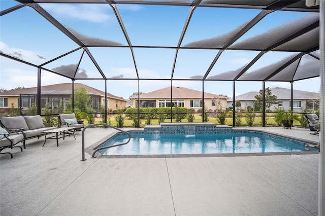 pool with a residential view, a patio area, and glass enclosure