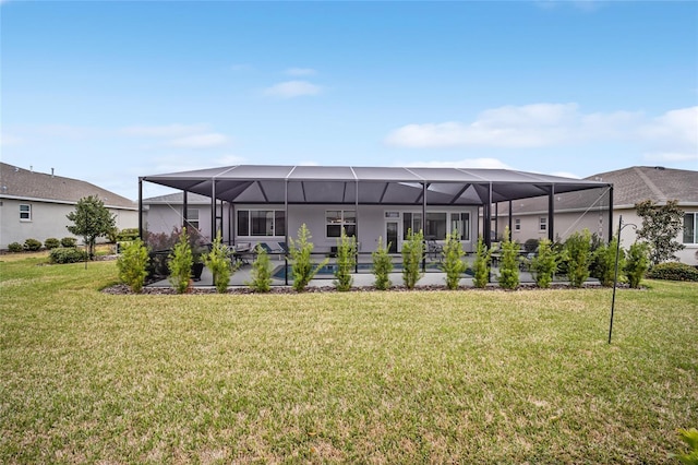 rear view of house with an outdoor pool, glass enclosure, and a yard