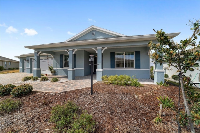 view of front facade featuring decorative driveway and stucco siding