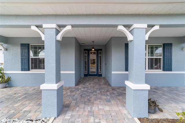 entrance to property with stucco siding