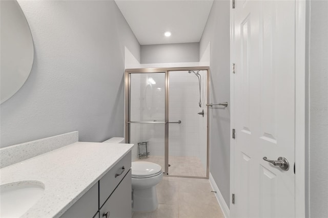 bathroom featuring baseboards, vanity, toilet, and a shower stall