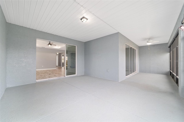 interior space with speckled floor and a ceiling fan