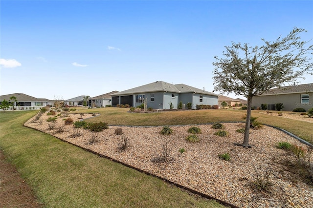 view of front of home featuring a residential view, an attached garage, and a front lawn