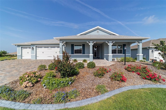 8107 SW 92nd Cir, Ocala, FL 34481 - view of front of property featuring a porch, stucco siding, a garage, and decorative driveway