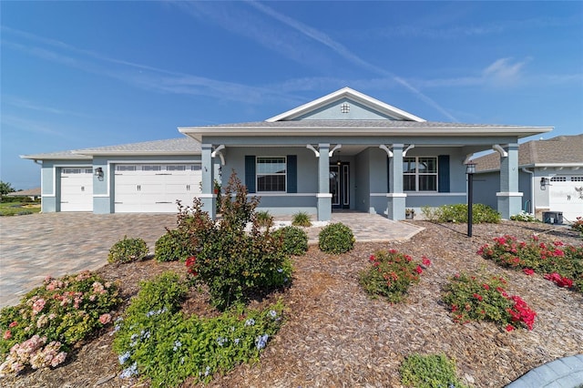 8107 SW 92nd Cir, Ocala, FL 34481 - view of front of house featuring a porch, stucco siding, decorative driveway, and an attached garage