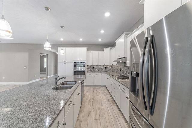 8107 SW 92nd Cir, Ocala, FL 34481 - kitchen with stainless steel appliances, a sink, under cabinet range hood, backsplash, and light wood finished floors