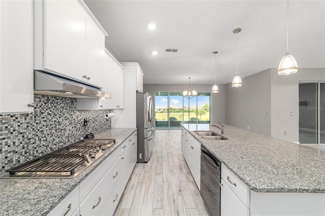 8107 SW 92nd Cir, Ocala, FL 34481 - kitchen featuring under cabinet range hood, stainless steel appliances, a sink, a chandelier, and light wood-type flooring