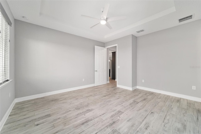 8107 SW 92nd Cir, Ocala, FL 34481 - unfurnished room with light wood-style flooring, ceiling fan, a raised ceiling, and baseboards