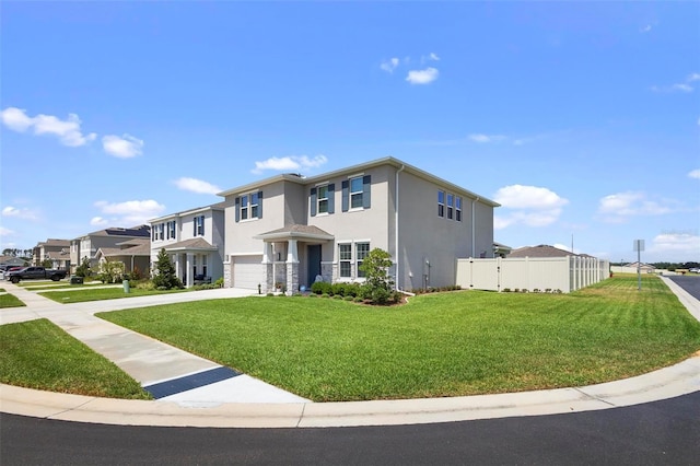 view of front facade featuring a garage, fence, concrete driveway, stucco siding, and a front yard