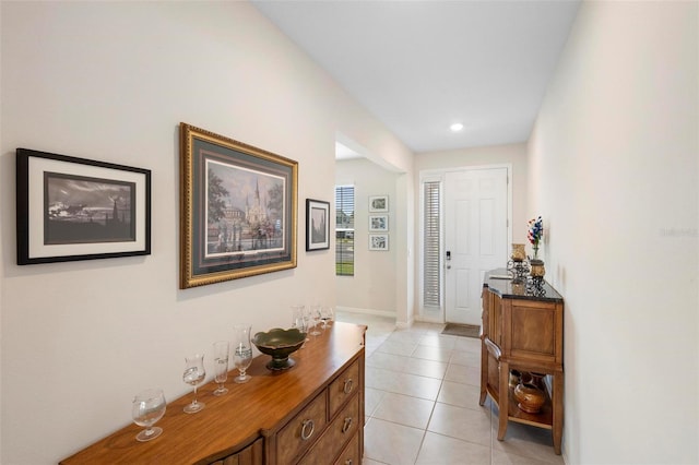 interior space featuring light tile patterned floors and baseboards