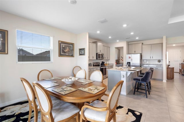 dining space with light tile patterned floors, baseboards, visible vents, and recessed lighting