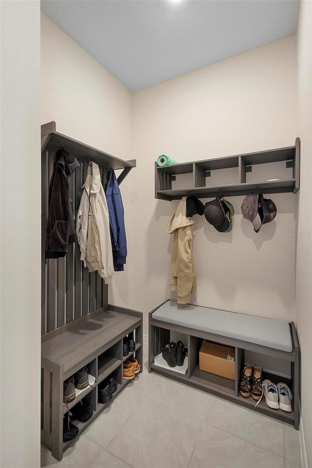 mudroom with baseboards and tile patterned floors