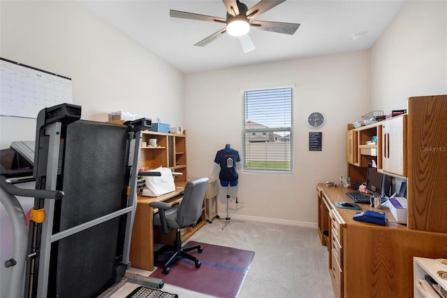 office area with light carpet, ceiling fan, and baseboards