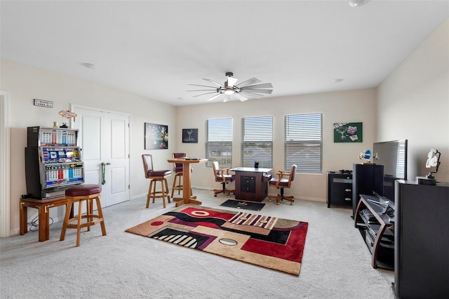 office with light carpet, a ceiling fan, and baseboards