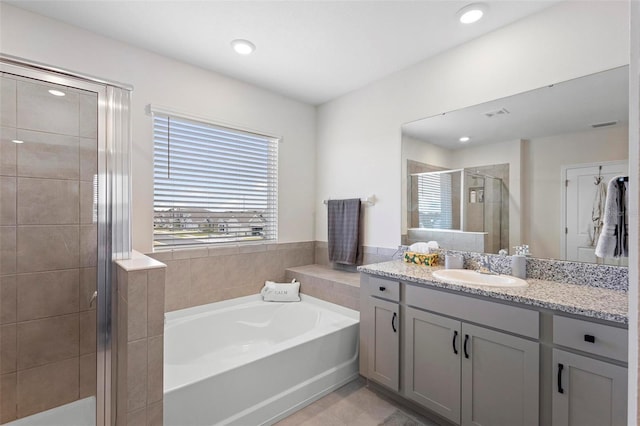 full bathroom featuring a stall shower, vanity, recessed lighting, and a bath