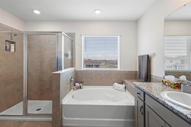 full bath with recessed lighting, a garden tub, a shower stall, and vanity