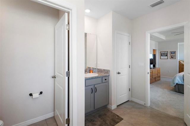 ensuite bathroom with ensuite bath, visible vents, baseboards, and vanity