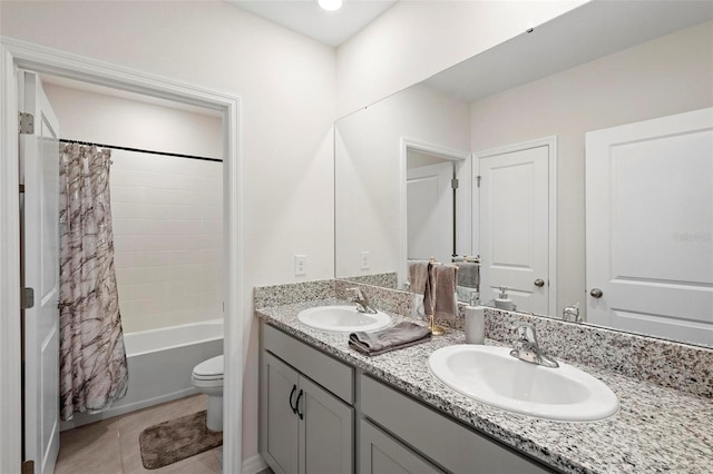 bathroom featuring double vanity, a sink, toilet, and shower / bathtub combination with curtain