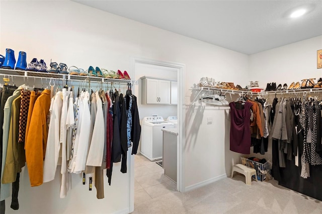 spacious closet featuring light carpet and washer and dryer